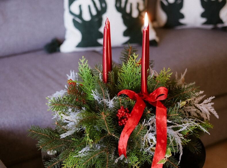 Christmas advent wreath with two lit red candles.